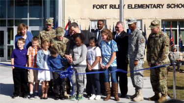 Kansas Gov. Sam Brownback, USD 475 Board of Education President Brian Field, USD 475 Superintendent Corbin Witt along with elementary school children and representatives of the Big Red One cut the ribbon for the new Fort Riley Elementary School in Fort Riley on Friday morning. 