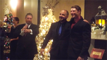 Riley County Police Department officer Brian Swearingen, middle, posed with Manhattan firefighter Gregg Van De Creek during Friday night's Festival of Trees Gala. The RCPD and MFD competed in the event's "Battle of the Badges" competition for best-decorated tree. Pictured left is Master of Ceremonies Dave Lewis. 