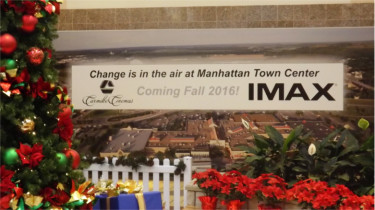 The former entrance to the Sears store in the Manhattan Town Center advertises the eventual opening of the mall's new IMAX theater. 