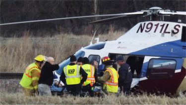 Emergency crews transport a crash victim to a Life Star helicopter. Riley County EMS Director Larry Couchman said at the scene the victim was in critical condition and was being transported to Topeka.