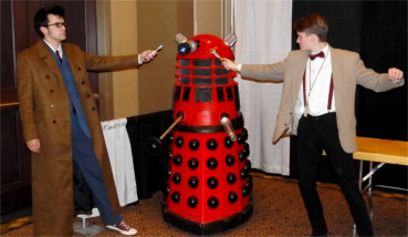 A duo of Dr. Who cosplayers pose in front of a "Red Dalek" inside the Manhattan Conference Center during Saturday's Little Apple Comic Con.