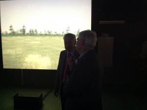 Governor's Military Council  Executive Director John Armbrust talks next to simulator screen.