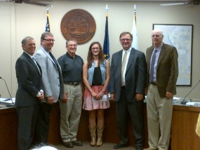 from left to right-County Commission Chair, Robert Boyd; Commissioner, Dave Lewis; KAC Official of the Year, Dennis Peterson; scholarship winner, Emma Glessner; KAC Executive Director, Randall Allen, and Commissioner, Ron Wells