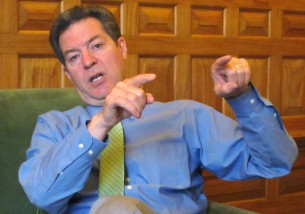 In this April 2015 photo, Kansas Republican Gov. Sam Brownback makes a point during an interview in his office in the Statehouse in Topeka. Brownback is preparing to sign welfare legislation restricting how poor families can spend cash assistance from the state. (AP Photo/John Hanna)