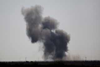 Smoke rises following an explosion in Egypt's northern Sinai Peninsula, as seen from the Israel-Egypt border, near Kerem Shalom town, southern Israel, Wednesday, July 1, 2015. Islamic militants on Wednesday unleashed a wave of simultaneous attacks, including suicide car bombings, on Egyptian army checkpoints in the restive northern Sinai Peninsula, killing tens of soldiers, security and military officials said. (AP Photo/Ariel Schalit)