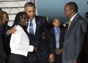 Kenyan President Uhuru Kenyatta, right, watches as President Barack Obama, center, hugs his half-sister Auma Obama, after he arrived at Kenyatta International Airport, on Friday, July 24, 2015, in Nairobi, Kenya. Obama is traveling on a two-nation African tour where he will become the the first sitting U.S. president to visit Kenya and Ethiopia. (AP Photo/Evan Vucci)