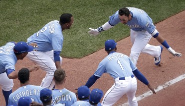 Kansas City Royals' Paulo Orlando, right, celebrates with teammates after hitting a walk-off grand slam during the ninth inning of the first game in a baseball doubleheader against the Tampa Bay Rays Tuesday, July 7, 2015, in Kansas City, Mo. The Royals won 9-5. (AP Photo/Charlie Riedel)