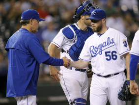 Kansas City Royals relief pitcher Greg Holland (56) is taken out of the game by manager Ned Yost, left, in the ninth inning of a baseball game against the Los Angeles Angels at Kauffman Stadium in Kansas City, Mo., Thursday, Aug. 13, 2015. Holland gave up four runs in the ninth. The Angles beat the Royals 7-6. (AP Photo/Colin E. Braley)