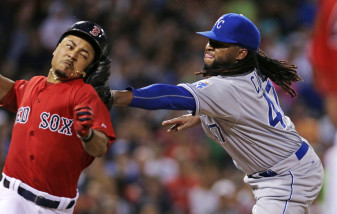 Kansas City Royals starting pitcher Johnny Cueto applies the tag to the head of Boston Red Sox's Mookie Betts as he attempts to leg out a single on a grounder during the sixth inning of a baseball game at Fenway Park in Boston, Friday, Aug. 21, 2015. (AP Photo/Charles Krupa)