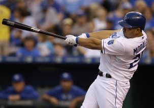 Kansas City Royals designated hitter Kendrys Morales hits a solo home run off Baltimore Orioles starting pitcher Miguel Gonzalez during the second inning of a baseball game at Kauffman Stadium, Tuesday, Aug. 25, 2015, in Kansas City, Mo. (AP Photo/Orlin Wagner)
