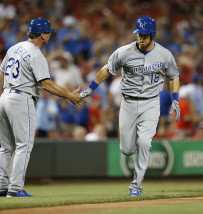 Kansas City Royals left fielder Ben Zobrist (18) is congratulated by third base coach Mike Jirschele as rounds the bases with a tying solo home run off Cincinnati Reds relief pitcher Aroldis Chapman (54) during the ninth inning of a baseball game, Tuesday, August 18, 2015, in Cincinnati. (AP Photo/Gary Landers)