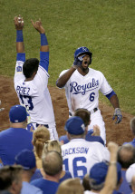 Kansas City Royals' Lorenzo Cain (6) celebrates with Salvador Perez (13) after Cain hit a solo home run during the sixth inning of a baseball game against the Detroit Tigers on Tuesday, Aug. 11, 2015, in Kansas City, Mo. (AP Photo/Charlie Riedel)