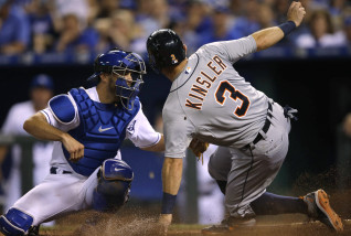 Detroit Tigers' Ian Kinsler (3) beats the tag by Kansas City Royals catcher Drew Butera, left, during the eighth inning of a baseball game at Kauffman Stadium in Kansas City, Mo., Wednesday, Aug. 12, 2015. Kinsler scored on a hit by Tyler Collins. (AP Photo/Orlin Wagner)