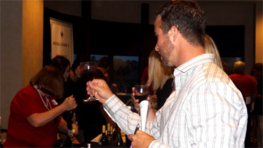 Joe Thorne of Manhattan takes a close look at a wine he sampled Saturday night in Bluemont Hotel for the 16th Annual Flint Hills Festival of Wines.