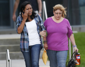 Lasamoa Cross, left, wipes tears from her face as she leaves the Arapahoe County Courthouse with Theresa Hoover, the mother of her boyfriend, Alexander J. Boik, who was killed in the theatre massacre, Friday, Aug. 7, 2015, in Centennial, Colo. James Holmes will be sentenced to life in prison without parole after a jury failed to agree on whether he should get the death penalty. (AP Photo/David Zalubowski)