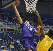 Kansas State guard Justin Edwards (14) drives past West Virginia forward Devin Williams (5) during the first half of an NCAA college basketball game, Wednesday, Feb. 11, 2015, in Morgantown, W.Va. (AP Photo/Raymond Thompson)