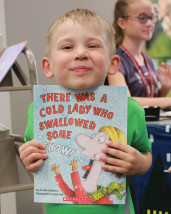 Owen Adams with a book during Summer Reading.