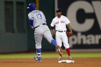 Kansas City Royals' Salvador Perez (13) rounds second base on his three-run home run as Boston Red Sox's Xander Bogaerts looks on during the sixth inning of a baseball game in Boston, Saturday, Aug. 22, 2015. (AP Photo/Michael Dwyer)