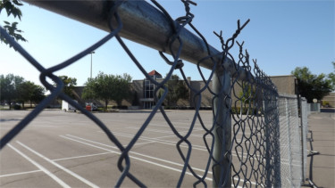 Fencing surrounds the old Sears wing at the Manhattan Town Center Friday afternoon. A demolition permit has been issued for the old Sears and a new IMAX movie theater is set to be put in its place. (Staff photo by Brady Bauman)