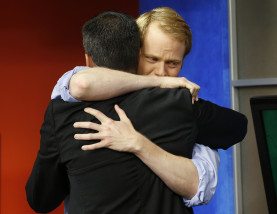 WDBJ-TV7 anchor Chris Hurst, right, hugs meteorologist Leo Hirsbrunner during the early morning newscast at WDBJ-TV7, in Roanoke, Va., Thursday, Aug. 27, 2015. Hurst was the fiance of Alison Parker, who was killed during a live broadcast Wednesday, in Moneta. (AP Photo/Steve Helber)