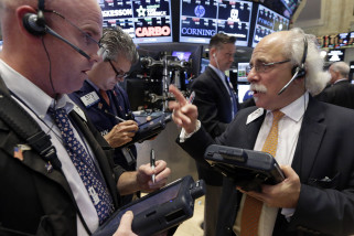 Traders Kevin Walsh, left, and Peter Tuchman, right, confer as they work on the floor of the New York Stock Exchange, Tuesday, Aug. 25, 2015. U.S. stocks closed lower Tuesday after falling sharply in the final hour of trading. (AP Photo/Richard Drew)