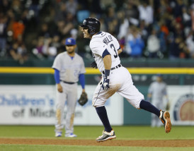 Detroit Tigers' Ian Kinsler celebrates his walk-off home run as he rounds the bases past Kansas City Royals' Christian Colon (24) during the 11th inning of a baseball game at Comerica Park Saturday, Sept. 19, 2015, in Detroit. The Tigers defeated the Royals 6-5. (AP Photo/Duane Burleson)