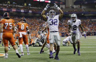 Kansas State's Justin Silmon (32) celebrates after he scored a touchdown against UTSA during the second half of an NCAA college football game, Saturday, Sept. 12, 2015, in San Antonio. Kansas State won 30-3. (AP Photo/Eric Gay)