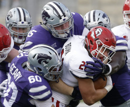 South Dakota running back Trevor Bouma (21) is tackled by Kansas State defensive tackles Will Geary (60), Travis Britz (95) and linebacker Elijah Lee, back right, during the first half of an NCAA college football game in Manhattan, Kan., Saturday, Sept. 5, 2015. (AP Photo/Orlin Wagner)