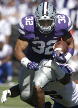 Kansas State running back Justin Silmon (32) is tackled by Louisiana Tech linebacker Beau Fitte (6) during the first half of an NCAA college football game in Manhattan, Kan., Saturday, Sept. 19, 2015. (AP Photo/Orlin Wagner)