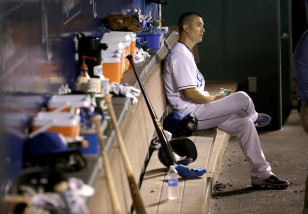 Kansas City Royals starting pitcher Jeremy Guthrie sits in the dugout after coming out of the game during the third inning after giving up nine runs to the Seattle Mariners, Tuesday, Sept. 22, 2015, in Kansas City, Mo. (AP Photo/Charlie Riedel)