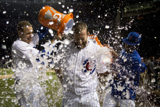 Chicago Cubs Chris Denorfia has water dumped on him by teammates Anthony Rizzo, left, and Dexter Fowler, right, after a walk-off home run against the Kansas City Royals during the 11th inning of a baseball game Monday, Sept. 28, 2015, in Chicago. The Cubs won 1-0 in 11 innings. (AP Photo/Andrew A. Nelles)