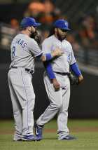 Kansas City Royals third baseman Mike Moustakas, left, talks with pitcher Johnny Cueto as he struggles against the Baltimore Orioles in the fourth inning of a baseball game, Sunday, Sept. 13, 2015, in Baltimore. The Orioles won 8-2. (AP Photo/Gail Burton)