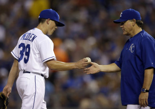 Kansas City Royals starting pitcher Kris Medlen (39) hands the ball to manager Ned Yost, right, during the sixth inning of a baseball game against the Chicago White Sox at Kauffman Stadium in Kansas City, Mo., Friday, Sept. 4, 2015. (AP Photo/Orlin Wagner)
