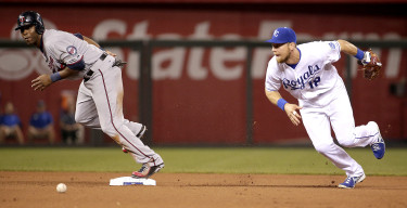 Minnesota Twins' Torii Hunter, left, is safe on second as Kansas City Royals second baseman Ben Zobrist (18) chases down the ball after Hunter advanced on a single by Kurt Suzuki during the sixth inning of a baseball game Monday, Sept. 7, 2015, in Kansas City, Mo. (AP Photo/Charlie Riedel)
