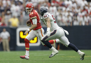 Kansas City Chiefs' Alex Smith (11) is chased by Houston Texans' John Simon (51) during the second half of an NFL football game Sunday, Sept. 13, 2015, in Houston. (AP Photo/Patric Schneider)