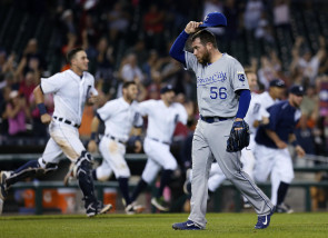 Kansas City Royals pitcher Greg Holland (56) walks off the field after giving up a game-winning RBI single to Detroit Tigers' Dixon Machado during the 12th inning of a baseball game Friday, Sept. 18, 2015, in Detroit. The Tigers defeated the Royals 5-4. (AP Photo/Duane Burleson)