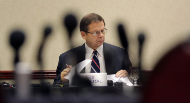 Mike Motheral, chairman of the University Interscholastic League (UIL) State Executive Committee, is seen through a cluster of microphones during an emergency meeting, Wednesday, Sept. 9, 2015, in Round Rock, Texas. The UIL, the governing body for high school sports in Texas, called the meeting to investigate two John Jay High School football players that hit a referee and the surrounding events. (AP Photo/Eric Gay)