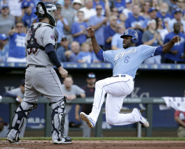 Kansas City Royals' Lorenzo Cain slides home past Cleveland Indians catcher Roberto Perez to score on a double by Eric Hosmer during the fourth inning of a baseball game, Sunday, Sept. 27, 2015, in Kansas City, Mo. (AP Photo/Charlie Riedel)