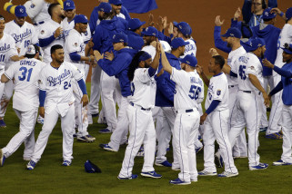 Kansas City Royals players celebrate on the field after their 7-2 win over the Houston Astros in Game 5 of baseball's American League Division Series, Wednesday, Oct. 14, 2015, in Kansas City, Mo.  (AP Photo/Colin E. Braley)