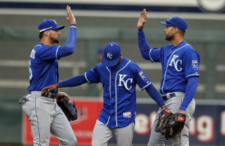 From left to right, Kansas City Royals left fielder Paulo Orlando, center fielder Jarrod Dyson and right fielder Alex Rios celebrate a 6-1 win over the Minnesota Twins in a baseball game Sunday, Oct. 4, 2015, in Minneapolis. (AP Photo/Bruce Kluckhohn)