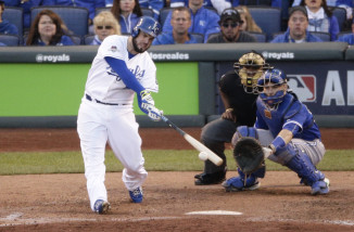 Kansas City Royals' Mike Moustakas hits a RBI single against the Toronto Blue Jays during the eighth inning in Game 2 of baseball's American League Championship Series on Saturday, Oct. 17, 2015, in Kansas City, Mo. (AP Photo/Jae C. Hong)