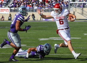 Oklahoma quarterback Baker Mayfield (6) runs away from Kansas State defensive backs Nate Jackson, bottom, and Donnie Starks (10) during the first half of an NCAA college football game in Manhattan, Kan., Saturday, Oct. 17, 2015. (AP Photo/Nati Harnik)