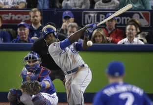 Kansas City Royals' Lorenzo Cain hits an RBI single against the Toronto Blue Jays during the seventh inning in Game 4 of baseball's American League Championship Series on Tuesday, Oct. 20, 2015, in Toronto. (AP Photo/Charlie Riedel)