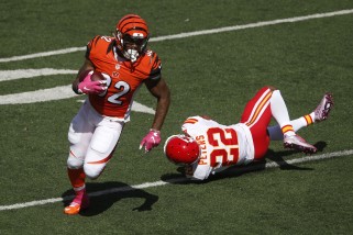 Cincinnati Bengals running back Jeremy Hill (32) evades Kansas City Chiefs cornerback Marcus Peters (22) on a touchdown run in the first half of a NFL football game, Sunday, Oct. 4, 2015, in Cincinnati. (AP Photo/Gary Landers)