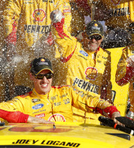Sprint Cup Series driver Joey Logano, bottom, celebrates in Victory Lane after winning a NASCAR auto race at Kansas Speedway in Kansas City, Kan., Sunday, Oct. 18, 2015. (AP Photo/Colin E. Braley)