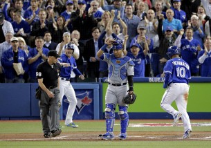 Kansas City Royals catcher Salvador Perez reacts after Toronto Blue Jays' Troy Tulowitzki's three run double during the sixth inning in Game 5 of baseball's American League Championship Series on Wednesday, Oct. 21, 2015, in Toronto. (AP Photo/Charlie Riedel)