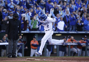 Kansas City Royals' Alcides Escobar reacts as he scores on a single by teammate Ben Zobrist during the seventh inning of Game 2 in baseball's American League Division Series against the Houston Astros, Friday, Oct. 9, 2015, in Kansas City, Mo. (AP Photo/Charlie Riedel)