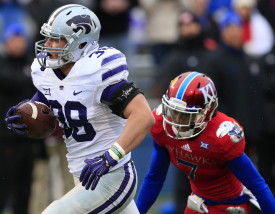 Kansas State fullback Winston Dimel (38) gains 44 yards before being tackled by Kansas defender Derrick Neal (7) during the first half of an NCAA college football game in Lawrence, Kan., Saturday, Nov. 28, 2015. (AP Photo/Orlin Wagner)