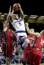 Kansas State's Barry Brown (5) gets past a group of South Dakota defenders to put up a shot during the second half of an NCAA college basketball game Friday, Nov. 20, 2015, in Manhattan, Kan. Kansas State won 93-72. (AP Photo/Charlie Riedel)