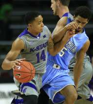 Kansas State guard Justin Edwards (14) is fouled by Columbia guard Nate Hickman (15) during the first half of an NCAA college basketball game in Manhattan, Kan., Monday, Nov. 16, 2015. (AP Photo/Orlin Wagner)